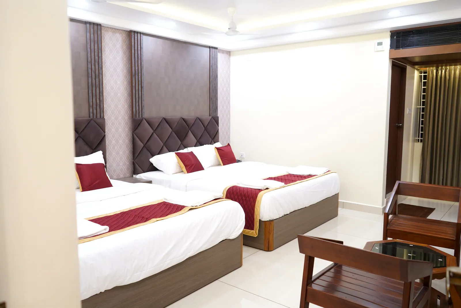 Super Deluxe room with two queen beds and wooden seating